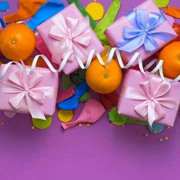 Decorative composition four boxes with gifts Satin ribbon Bow Oranges Confett Stock Photos