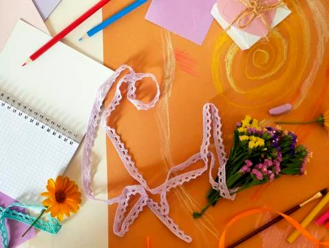 Decorative composition of hand-crafted items on yellow toned paper Stock Photos