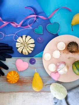 Decorative composition of pumpkins, pears, stitched dolls and felt hearts Stock Photos