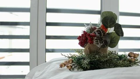 Decorative composition on a snow-white bed against the background of a window Stock Photos