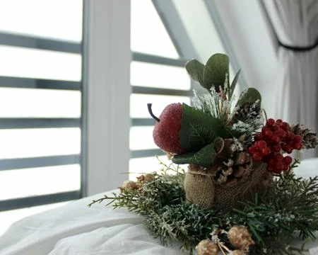 Decorative composition on a snow-white bed against the background of a window Stock Photos