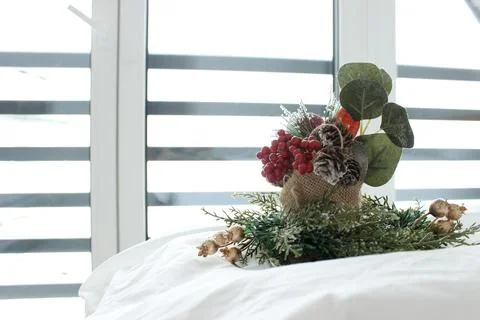 Decorative composition on a snow-white bed against the background of a window Stock Photos