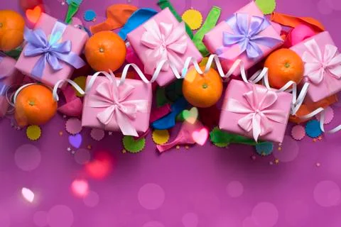Decorative composition Three boxes with gifts Satin ribbon Bow Oranges Confet Stock Photos