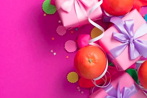 Decorative composition Three boxes with gifts Satin ribbon Bow Oranges Confet Stock Photos