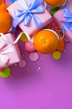 Decorative composition Three boxes with gifts Satin ribbon Bow Oranges Confet Stock Photos