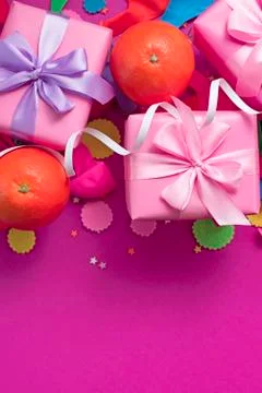Decorative composition Three boxes with gifts Satin ribbon Bow Oranges Confet Stock Photos