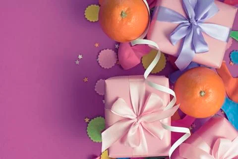 Decorative composition Three boxes with gifts Satin ribbon Bow Oranges Confet Stock Photos