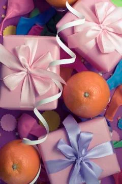 Decorative composition Three boxes with gifts Satin ribbon Bow Oranges Confet Stock Photos