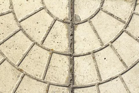 Decorative concrete pattern showing circular lines and segments in a light beige Stock Photos