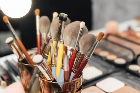 Decorative cosmetics on dressing table in makeup room Stock Photos
