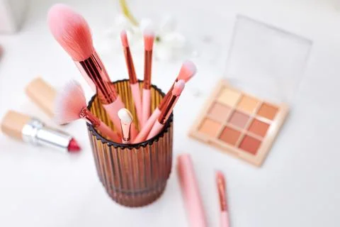 Decorative cosmetics on dressing table in makeup room Stock Photos