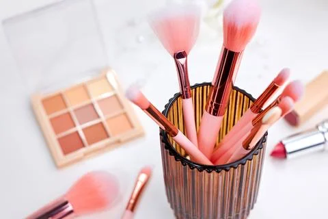 Decorative cosmetics on dressing table in makeup room Stock Photos