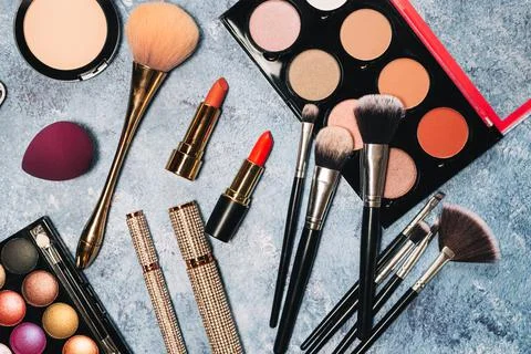Decorative cosmetics, makeup brushes false eyelashes on a blue background. the Stock Photos