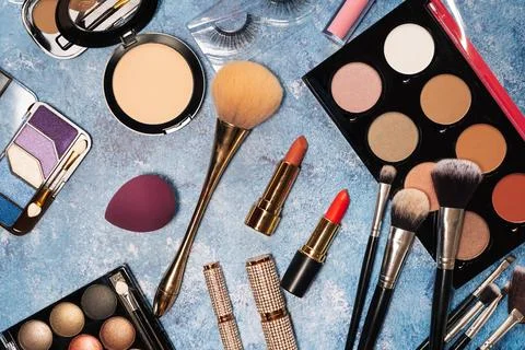 Decorative cosmetics, makeup brushes false eyelashes on a blue background. the Stock Photos