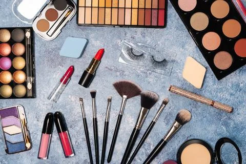 Decorative cosmetics, makeup brushes false eyelashes on a blue background. the Stock Photos