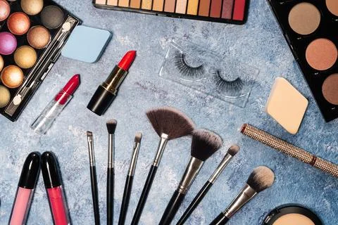 Decorative cosmetics, makeup brushes false eyelashes on a blue background. the Stock Photos