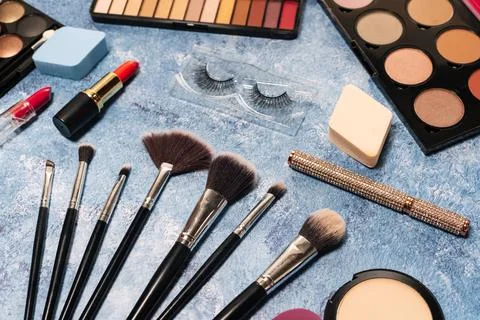 Decorative cosmetics, makeup brushes false eyelashes on a blue background. the Stock Photos