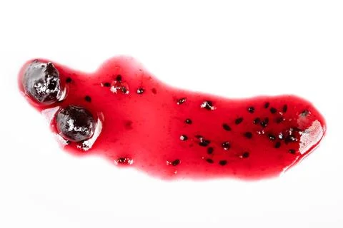 Decorative crimson jelly droplets with tiny pearllike fruit accents. Vibrant red 库存照片