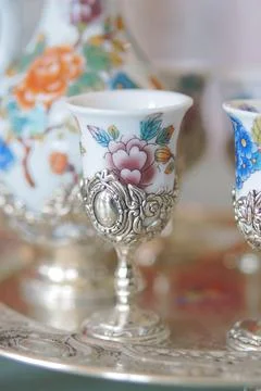 Decorative cups and silver tray in a bright setting Stock Photos