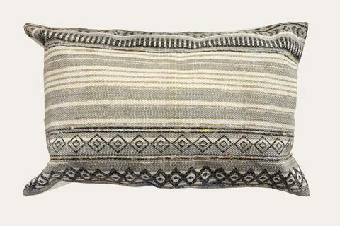 Decorative cushion with knitted pattern. Stock Photos