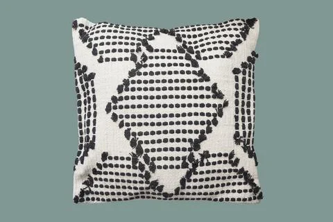 Decorative cushion with knitted pattern. Stock Photos
