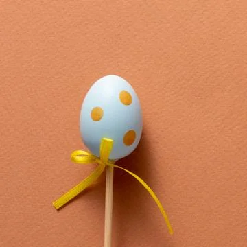 Decorative decoration in the form of Easter eggs on a terracotta background.  Stock Photos