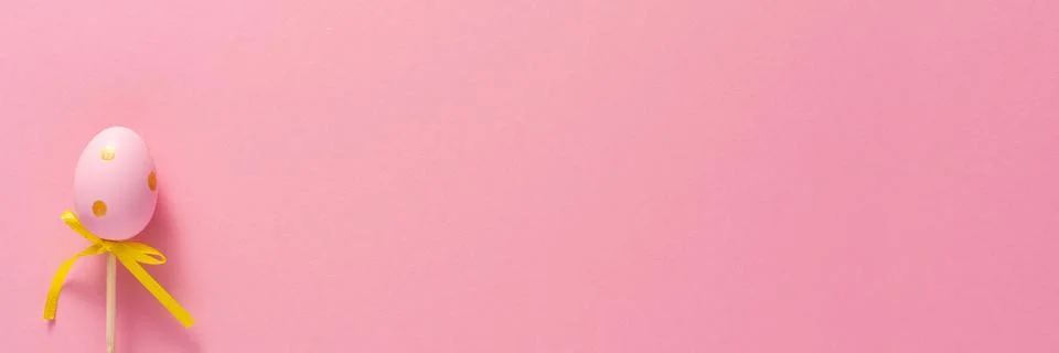 Decorative decoration in the form of Easter eggs on a pink background. Copy s Stock Photos