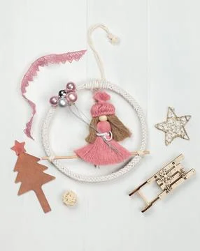 Decorative doll made of thread on a light wooden background, with a New Year's Stock Photos