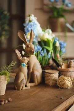 Decorative Easter bunnies with spring flowers and gardening tools Stock Photos