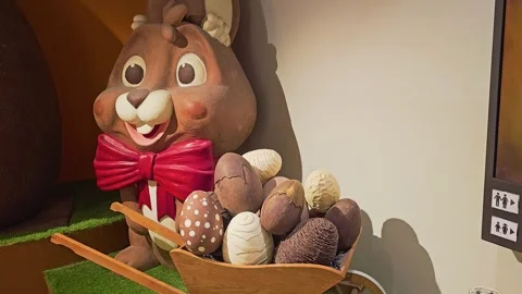 Decorative Easter bunny display with a large smiling rabbit, red bow tie Stock Footage 335220483