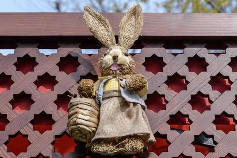 Decorative Easter bunny made of grass straws in display on a wooden surface Stock Photos