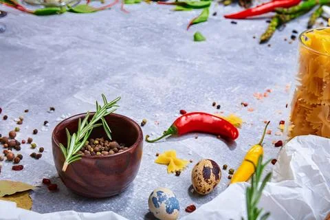 Decorative easter eggs and chili peppers on table Stock Photos