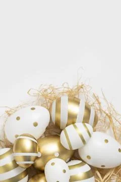 Decorative Easter eggs and straw on a white background Stock Photos