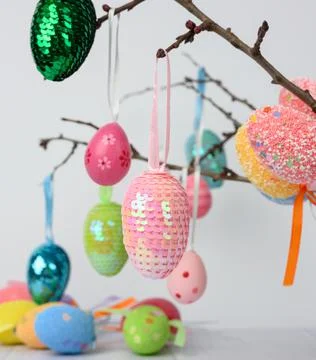 Decorative easter eggs hang on a branch, white background Stock Photos