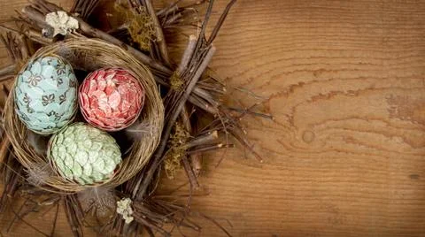 Decorative easter eggs made of paper in nest Stock Photos