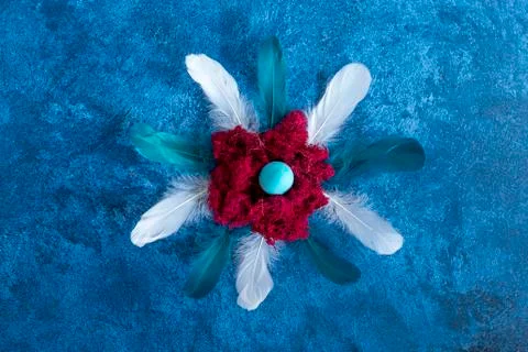Decorative easter eggs in nest and feathers. Dark blue background. Holiday de Stock Photos