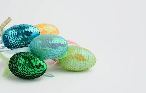 Decorative Easter eggs with sequins on a white background Stock Photos