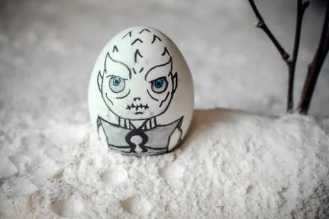 Decorative Easter eggs in snow with mountains background. DIY concept. Stock Photos