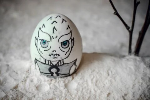 Decorative Easter eggs in snow with mountains background. DIY concept. Stock Photos