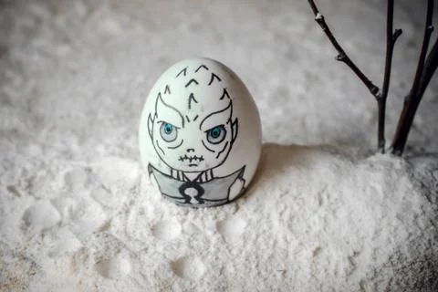 Decorative Easter eggs in snow with mountains background. DIY concept. Stock Photos