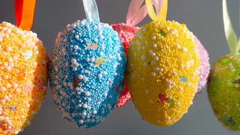 Decorative Easter eggs swing on a light background Stock Footage 105926243