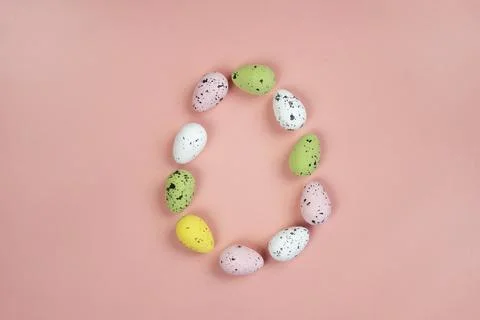 Decorative eggs on a pink background. Frame in the form of an Easter egg. Stock Photos