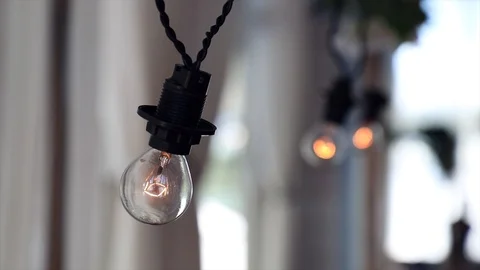 Decorative electric lights decorates the hall in the restaurant Stock Footage 99336418