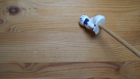 Decorative element - ceramic shape of cat moving on wooden background Stock Footage 93075096