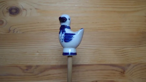 Decorative element - ceramic shape of duck moving on wooden background Stock Footage 93072760