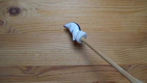 Decorative element - ceramic shape of moon moving on wooden background Stock Footage 93072235