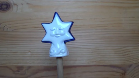 Decorative element - ceramic shape of star moving on wooden background Stock Footage 93068128