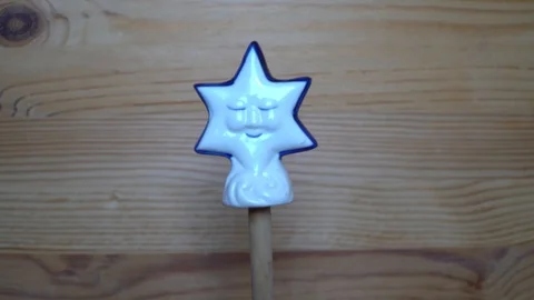 Decorative element - ceramic shape of star moving on wooden background Stock Footage 93068478