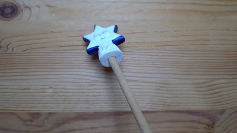 Decorative element - ceramic shape of star moving on wooden background Stock Footage 93068806