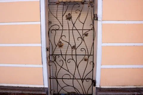 Decorative elements of buildings, old cast-iron wrought-iron grilles on doors Fotos de archivo